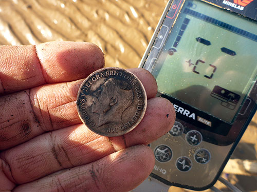 Minelab X-Terra Elite on the beach with coin found